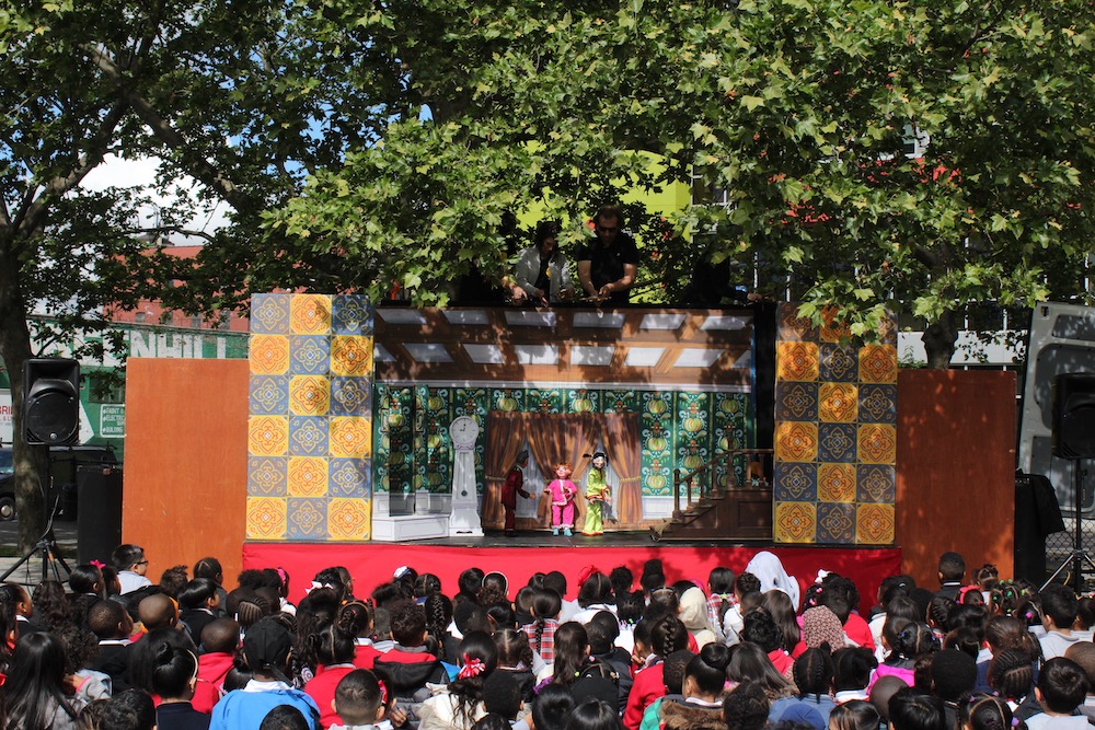 The Puppetmobile stage with two puppeteers above it.